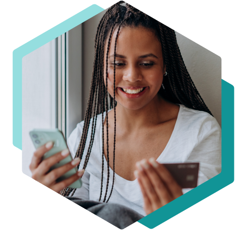 Woman holding mobile phone and credit card